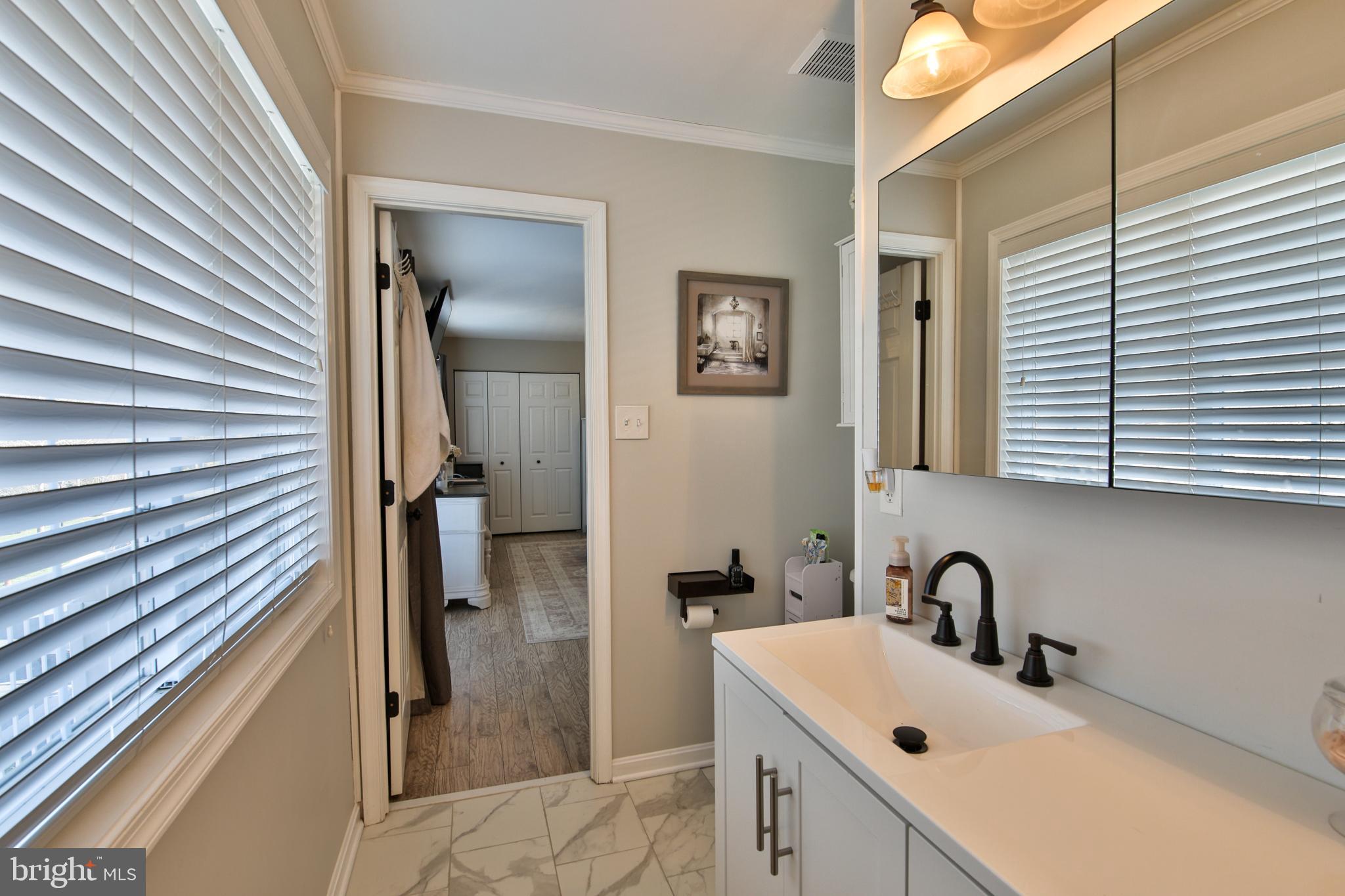 201 Mariners Point Drive Middle River, MD 21220 - Photo 31 of 53 a bathroom with a sink a toilet and mirror