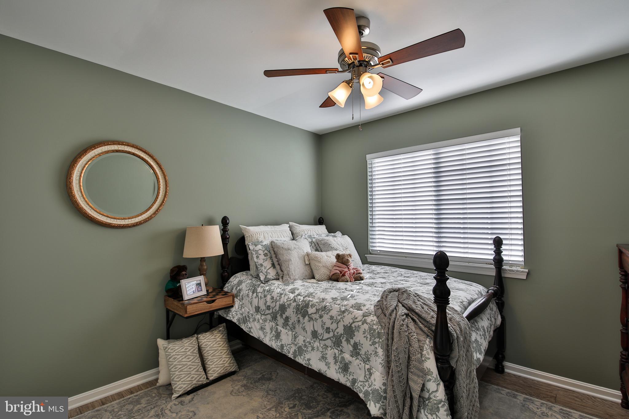 201 Mariners Point Drive Middle River, MD 21220 - Photo 34 of 52 a bedroom with a bed and a chandelier
