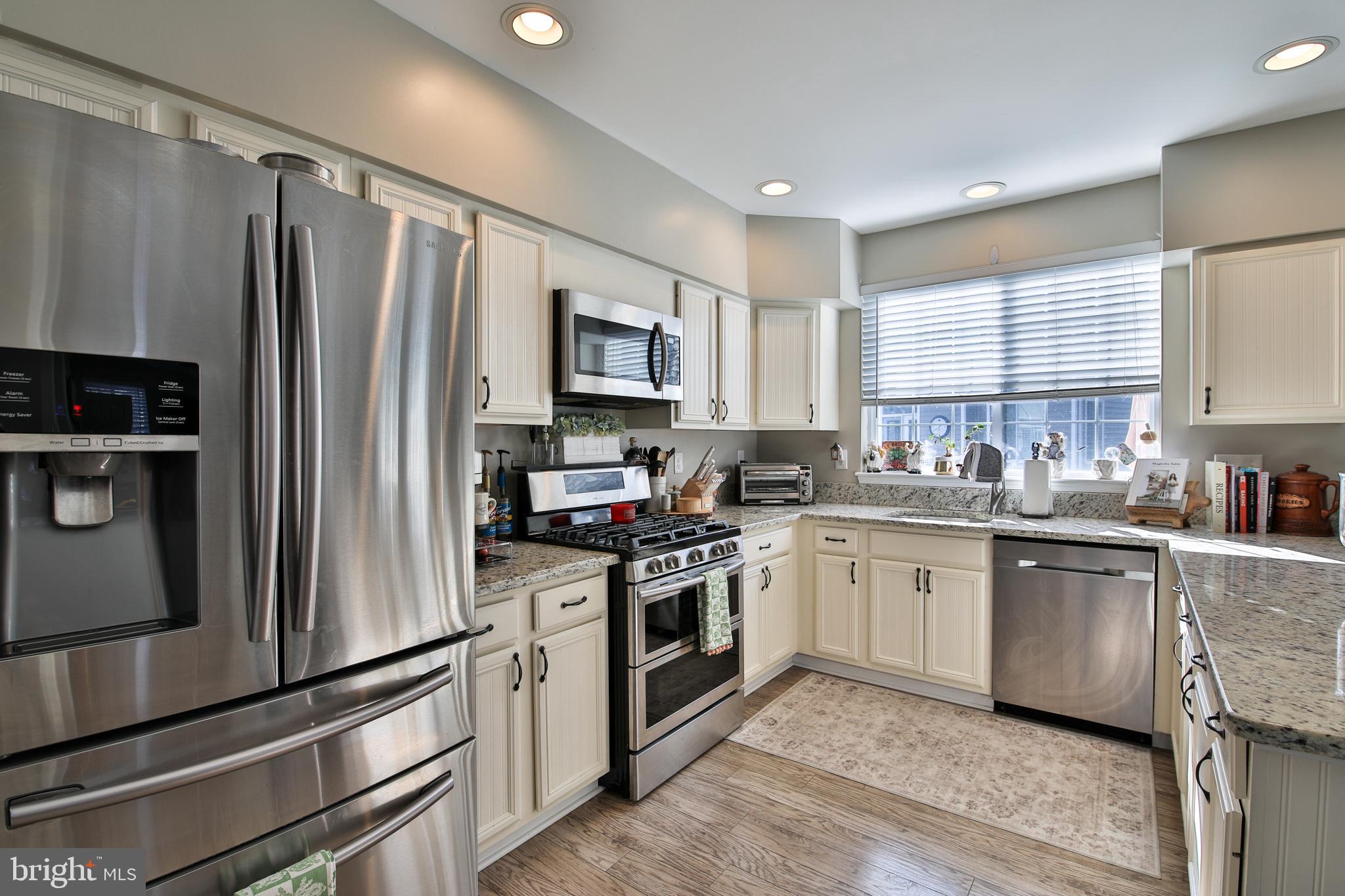 201 Mariners Point Drive Middle River, MD 21220 - Photo 8 of 52 a kitchen with stainless steel appliances a refrigerator sink and microwave