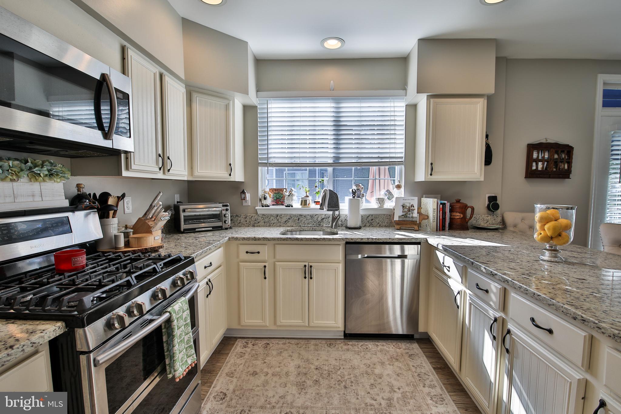 201 Mariners Point Drive Middle River, MD 21220 - Photo 8 of 53 a kitchen with stainless steel appliances granite countertop a stove a sink and a microwave