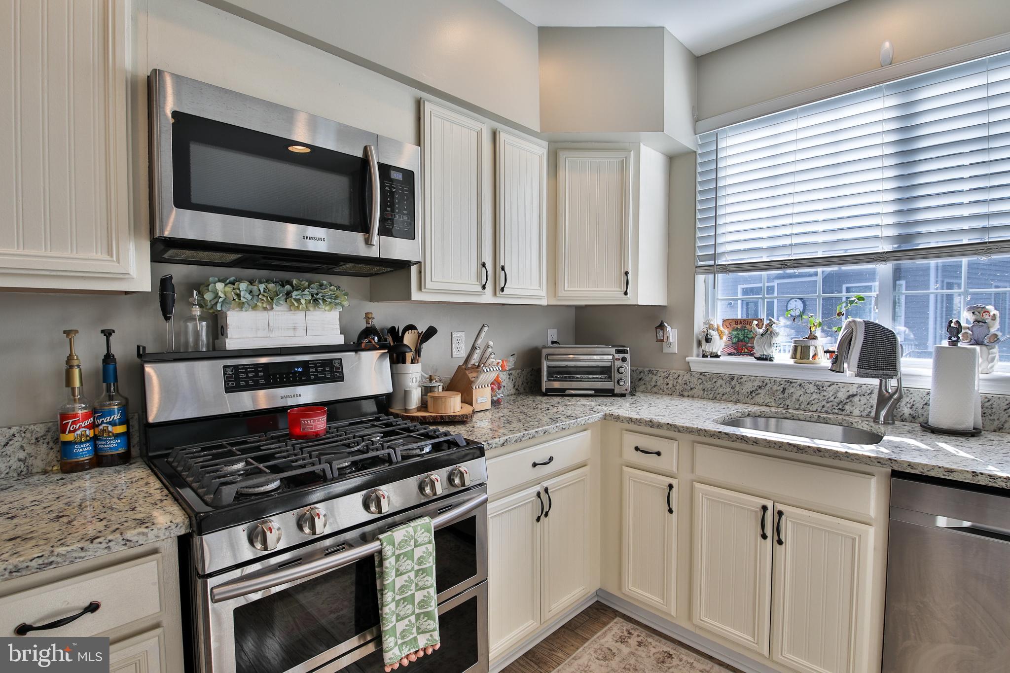 201 Mariners Point Drive Middle River, MD 21220 - Photo 10 of 53 a kitchen with stainless steel appliances granite countertop a sink stove top oven and microwave