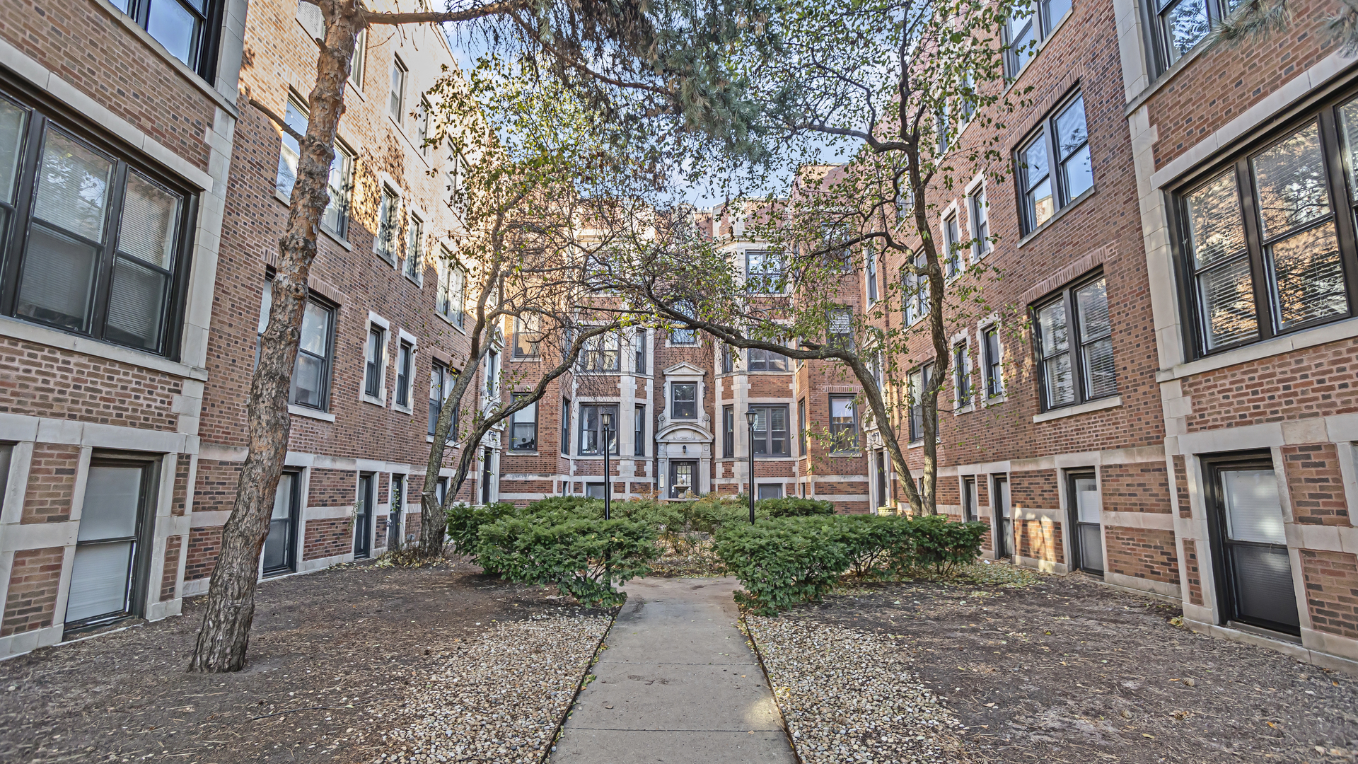 a view of a brick building next to a road