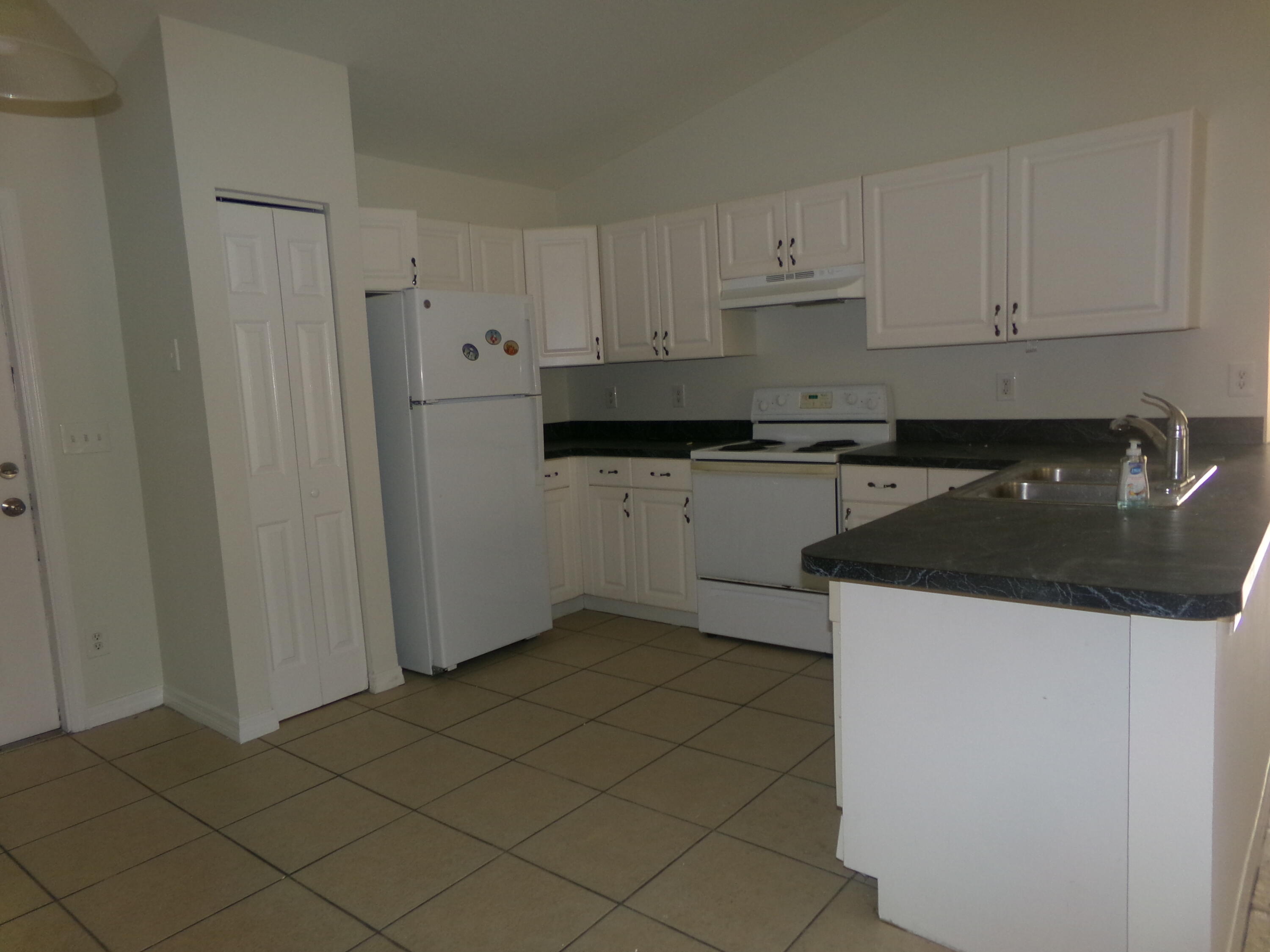 319 15th Street Southwest Vero Beach, FL 32962 - Photo 4 of 9 a kitchen with a sink and cabinets