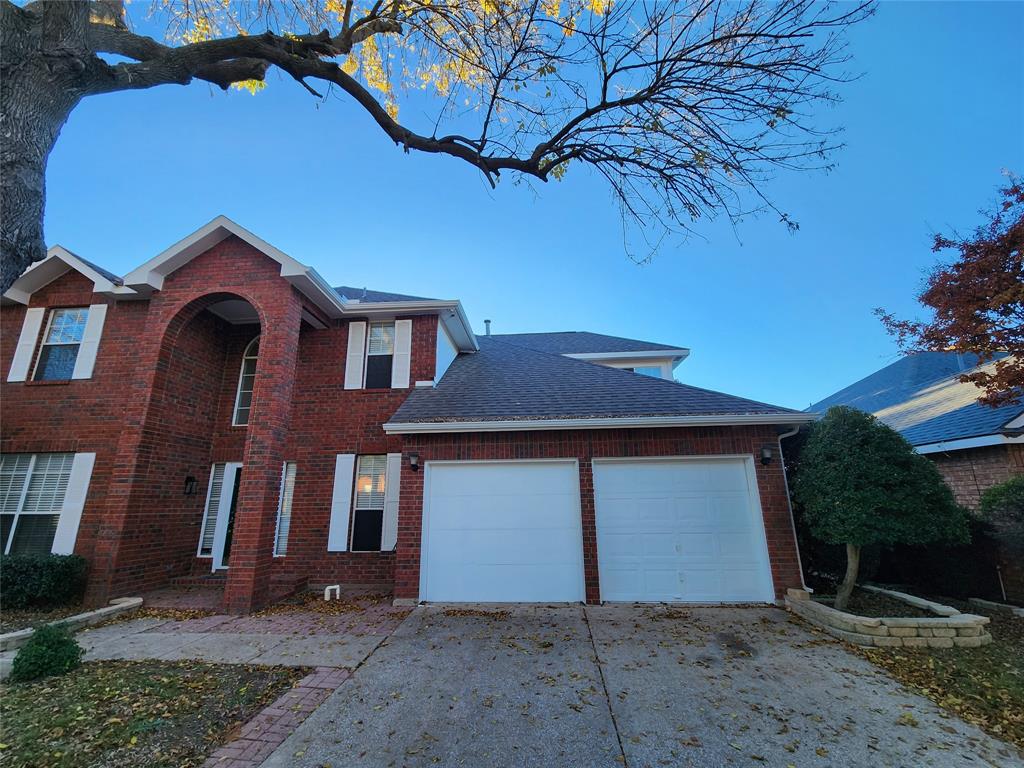 2413 Timber Ridge Lane Flower Mound, TX 75028 - Photo 2 of 32 Two-story brick exterior featuring white shutters and arched entryway