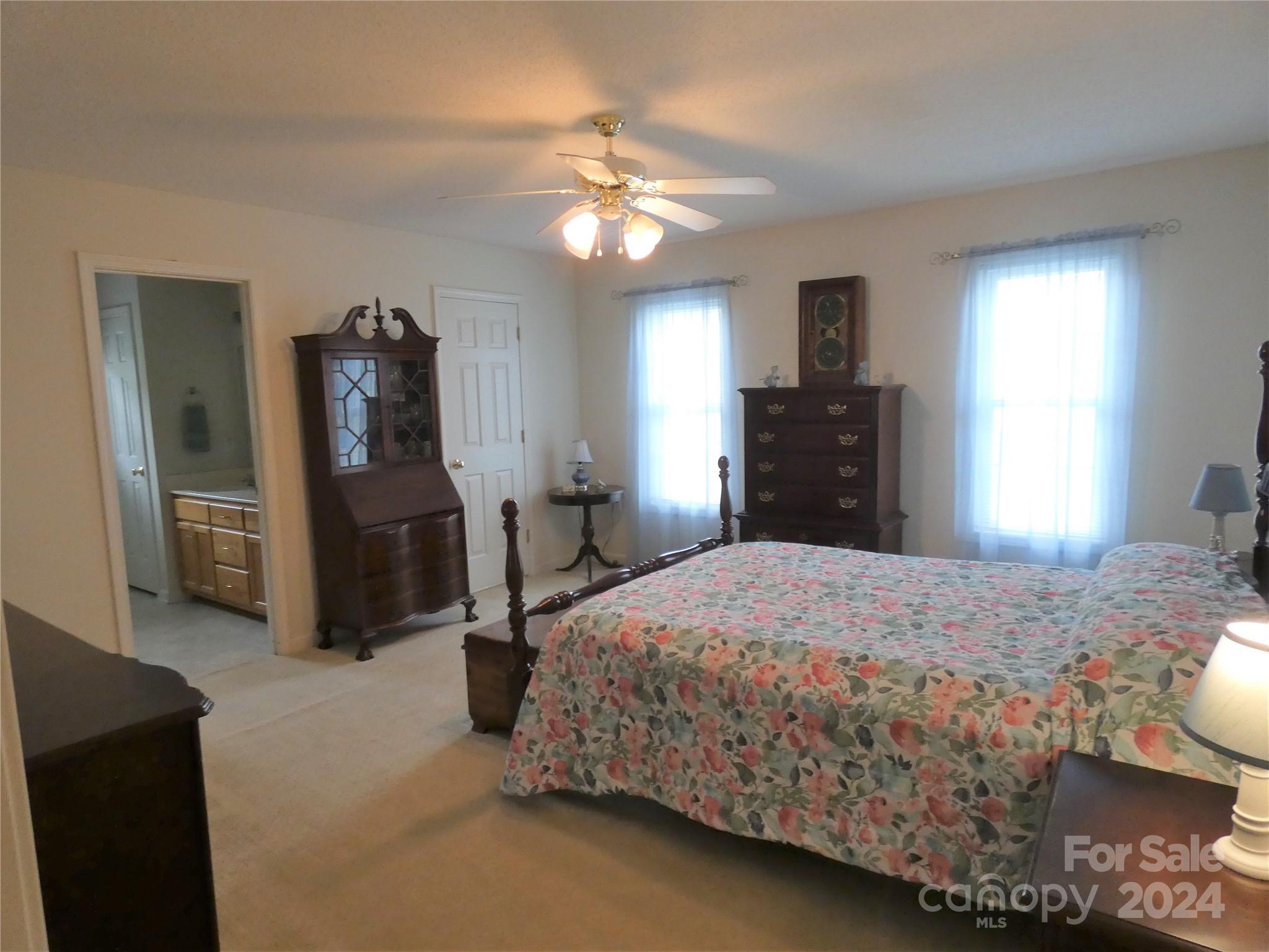 3803 River Road Hickory, NC 28602 - Photo 13 of 24 a bedroom with a bed and a chandelier