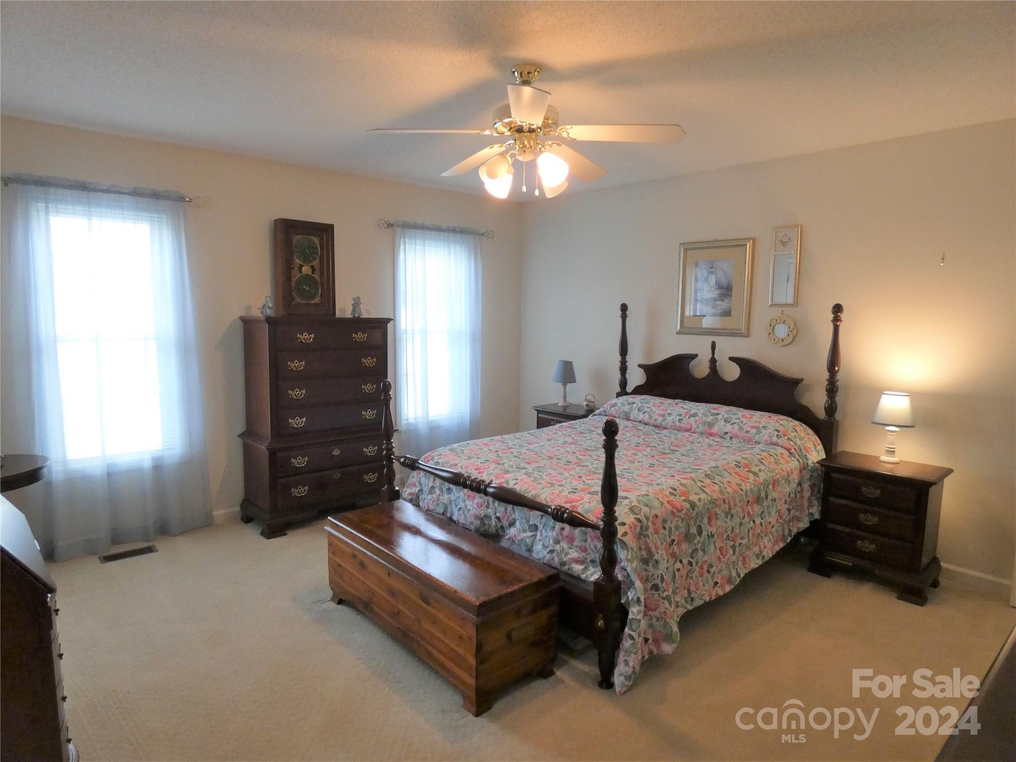 3803 River Road Hickory, NC 28602 - Photo 14 of 24 a bedroom with a bed and a chandelier