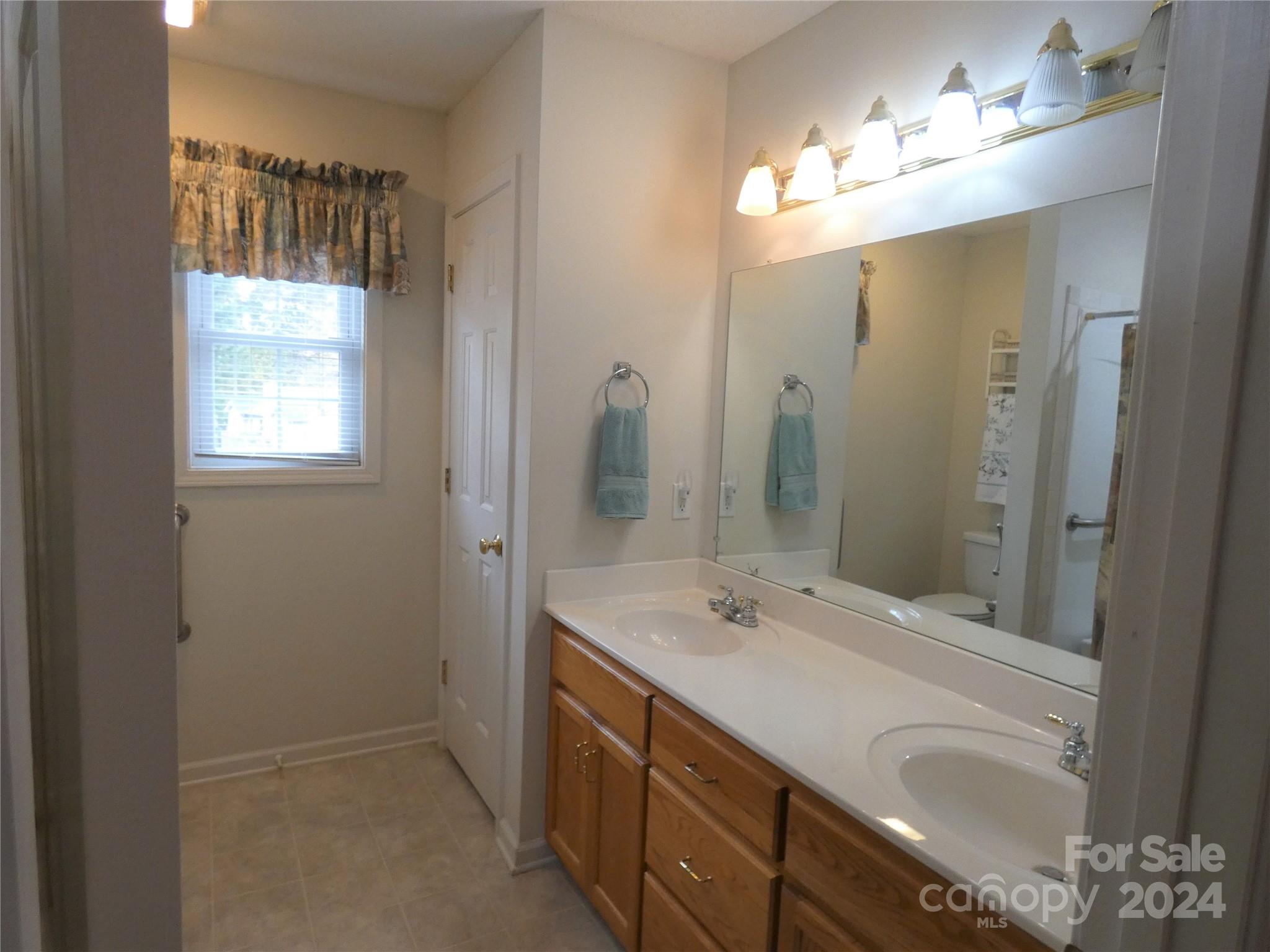 3803 River Road Hickory, NC 28602 - Photo 16 of 24 a bathroom with a double vanity sink and a mirror