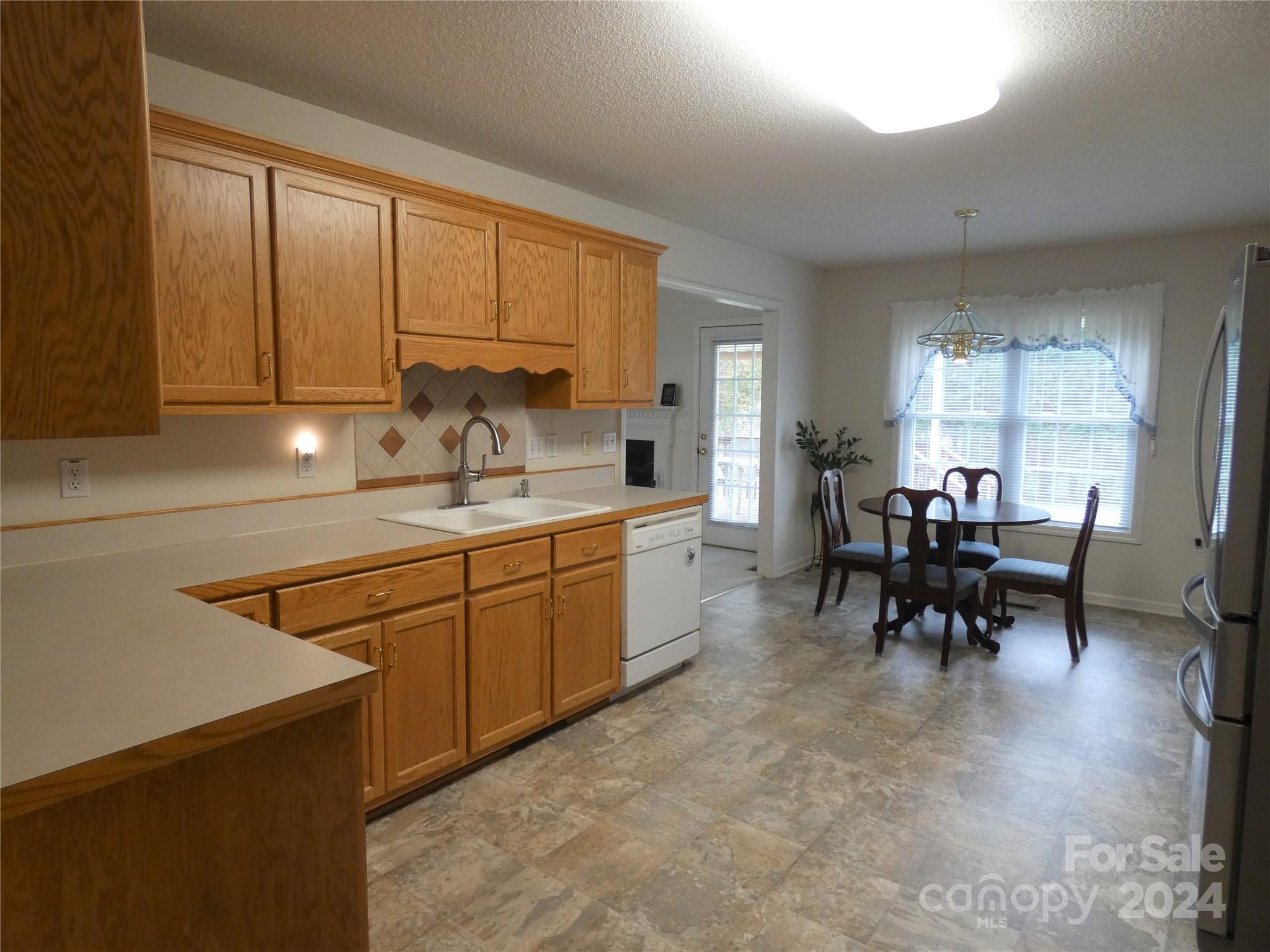3803 River Road Hickory, NC 28602 - Photo 3 of 24 a kitchen with table chairs cabinets and stainless steel appliances