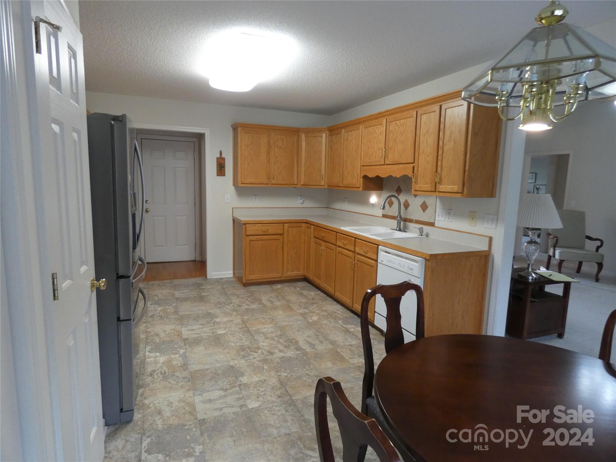 3803 River Road Hickory, NC 28602 - Photo 4 of 24 a kitchen with stainless steel appliances granite countertop a sink a stove a dining table and chairs