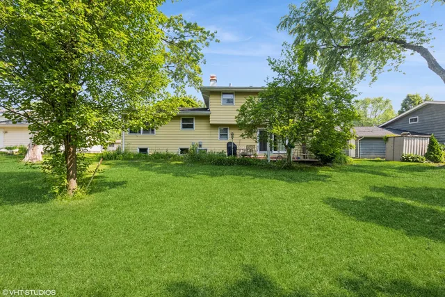 a view of house with backyard