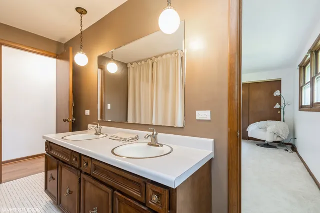 a bathroom with a sink double vanity and a mirror
