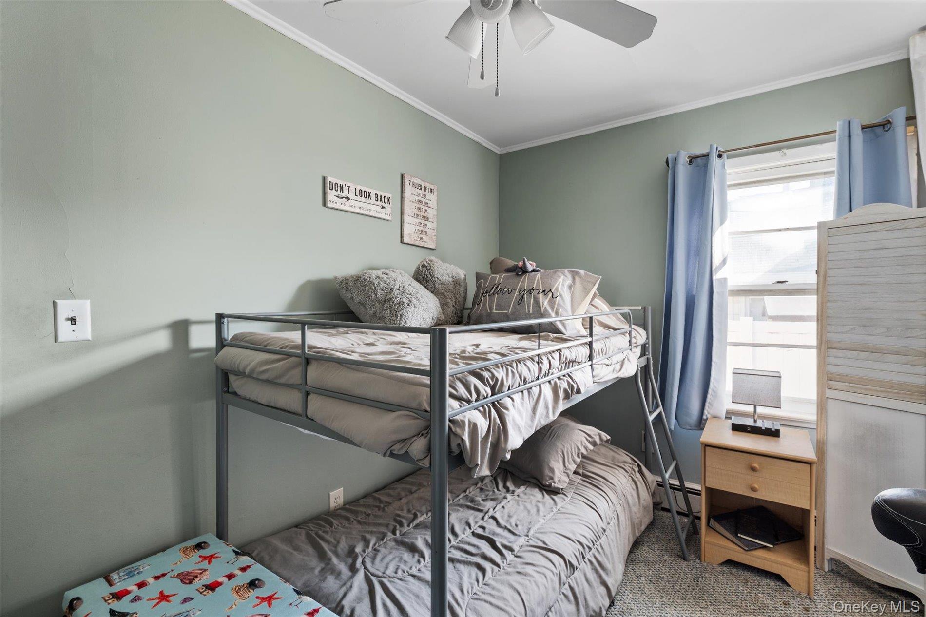 8 July Walk Long Beach, NY 11561 - Photo 13 of 14 a bedroom with a bed and a chandelier