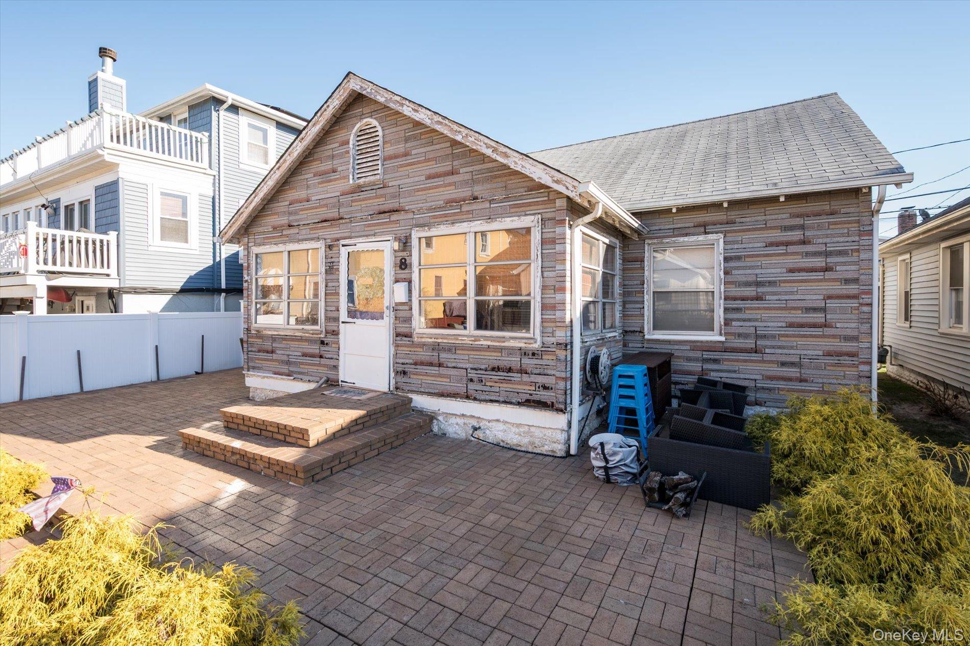 8 July Walk Long Beach, NY 11561 - Photo 2 of 14 a backyard of a house with barbeque oven and outdoor seating