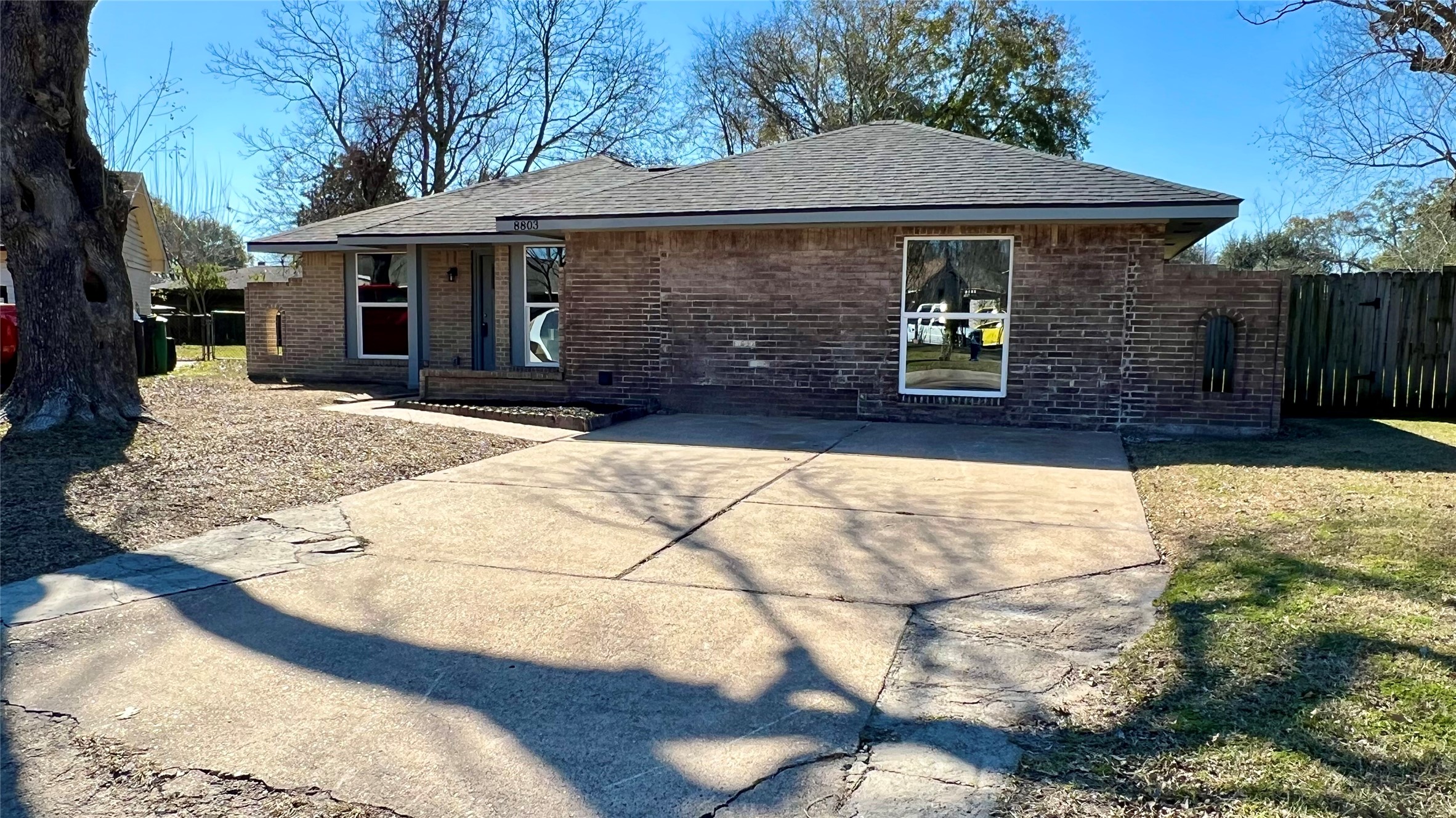8803 Cottage Gate Lane Houston, TX 77088 - Photo 1 of 32 a front view of a house with a yard