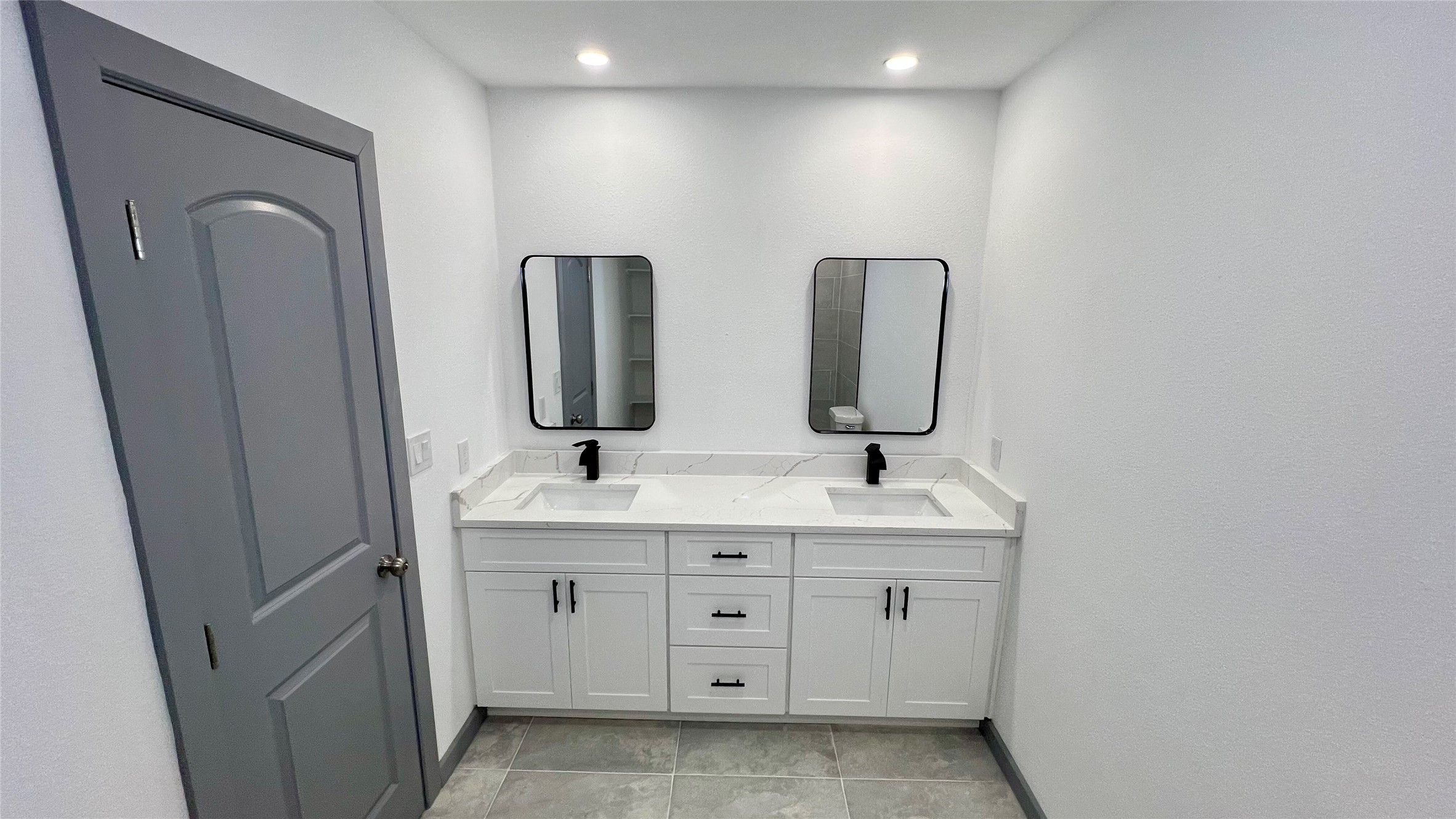 8803 Cottage Gate Lane Houston, TX 77088 - Photo 16 of 32 a spacious bathroom with double vanity and mirrors