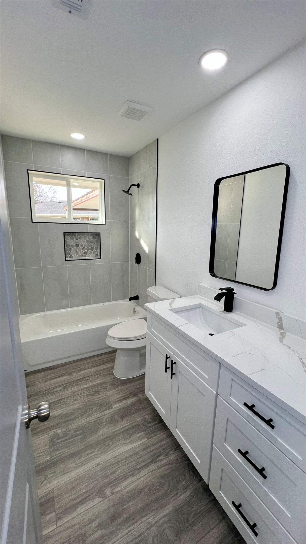 8803 Cottage Gate Lane Houston, TX 77088 - Photo 23 of 32 a bathroom with a double vanity sink a toilet and mirror
