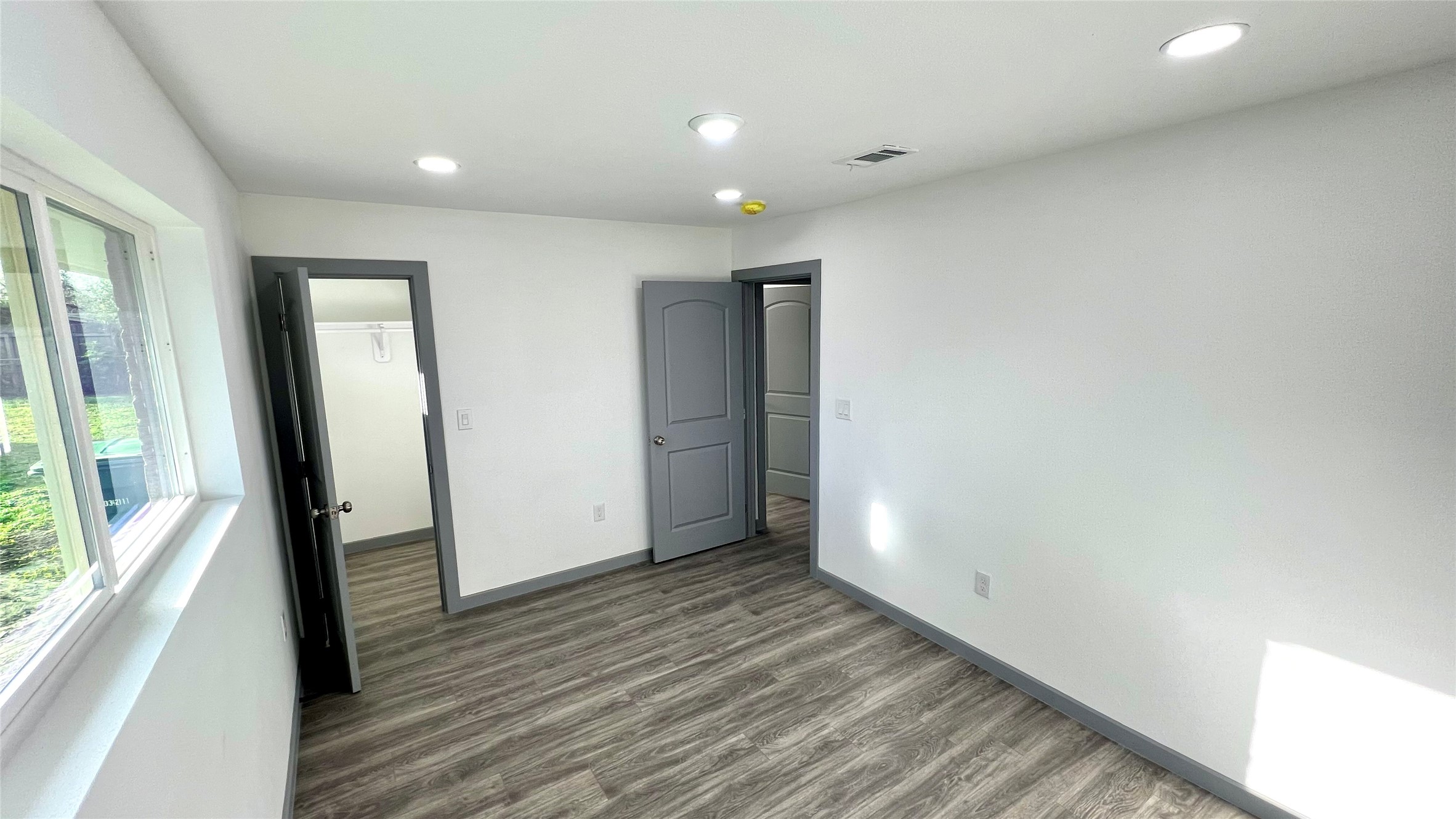 8803 Cottage Gate Lane Houston, TX 77088 - Photo 26 of 32 wooden floor in an empty room with a window