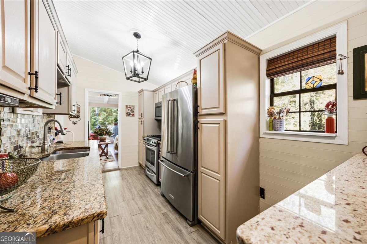 606 Morgan Road Juliette, GA 31046 - Photo 12 of 35 a view of a kitchen with refrigerator and wooden floor