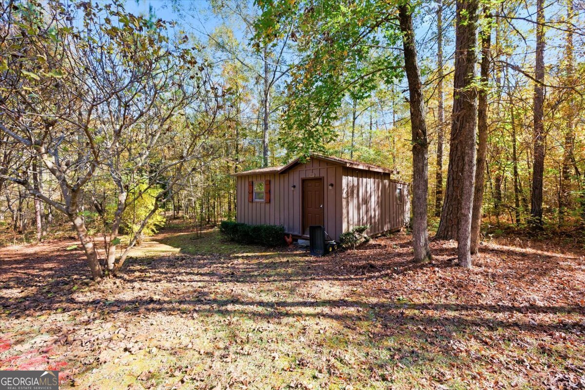 606 Morgan Road Juliette, GA 31046 - Photo 31 of 35 a backyard of a house with large trees and wooden fence