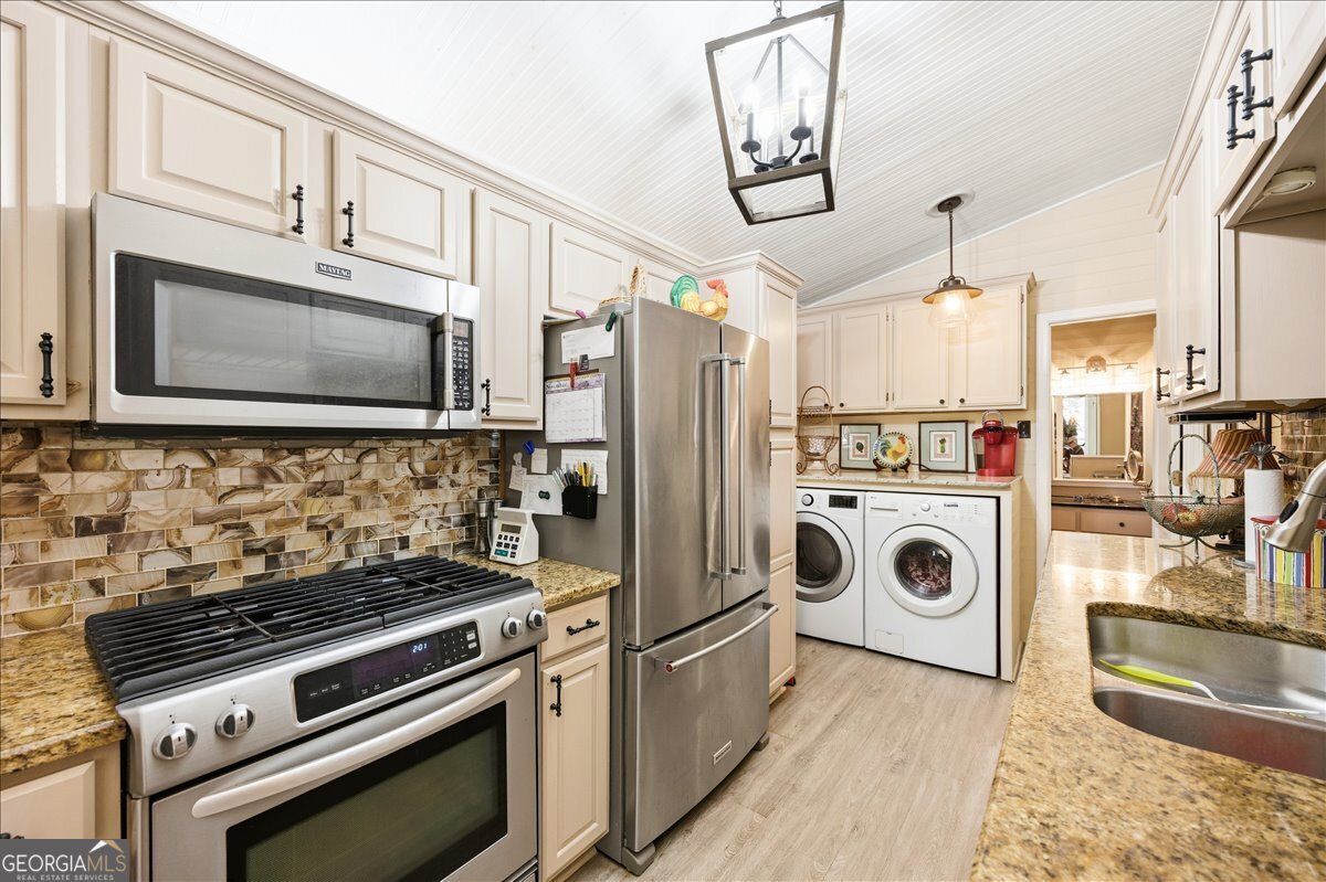606 Morgan Road Juliette, GA 31046 - Photo 10 of 35 a kitchen with a stove and a microwave