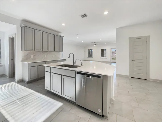 a kitchen with kitchen island a sink stainless steel appliances and cabinets