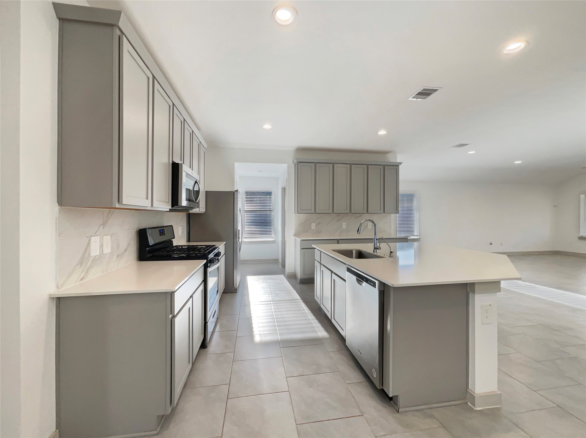 29811 Cayenne Circle Katy, TX 77494 - Photo 2 of 21 a kitchen with stainless steel appliances a sink stove top oven and cabinets