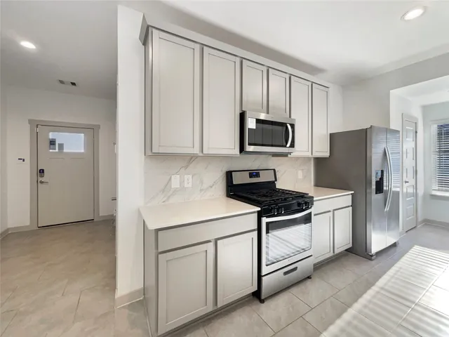 a kitchen with a sink cabinets and appliances