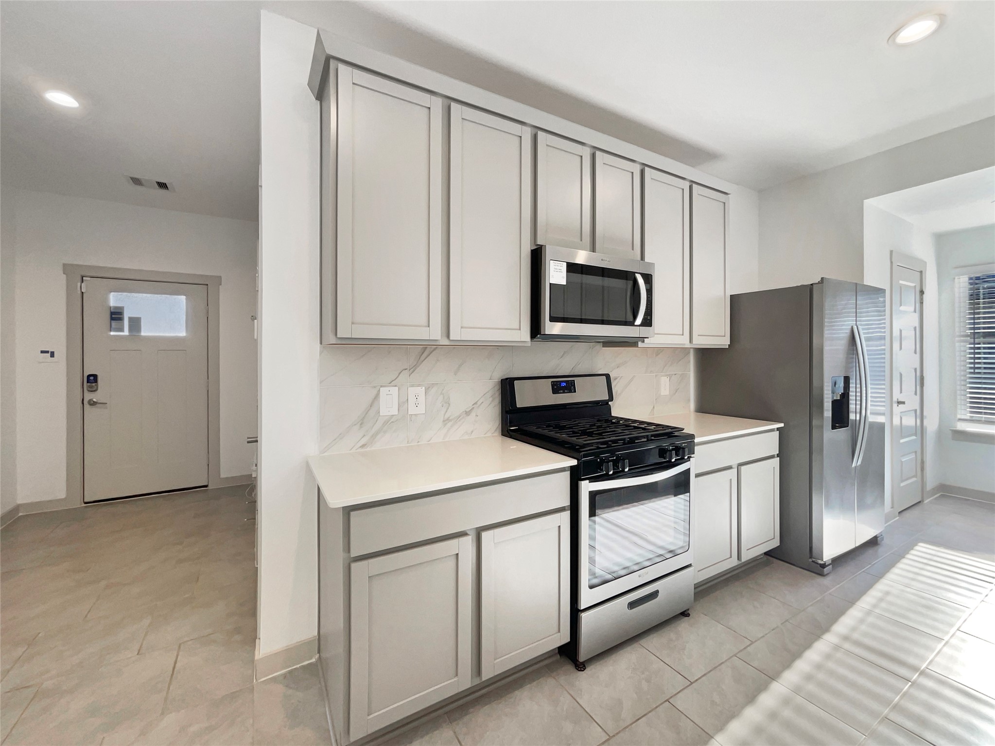 29811 Cayenne Circle Katy, TX 77494 - Photo 10 of 21 a kitchen with stainless steel appliances granite countertop a stove a refrigerator and a microwave