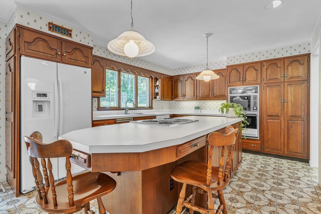 63 Ardsley Road Longmeadow, MA 01106 - Photo 12 of 41 a kitchen with stainless steel appliances granite countertop a sink a stove and a refrigerator