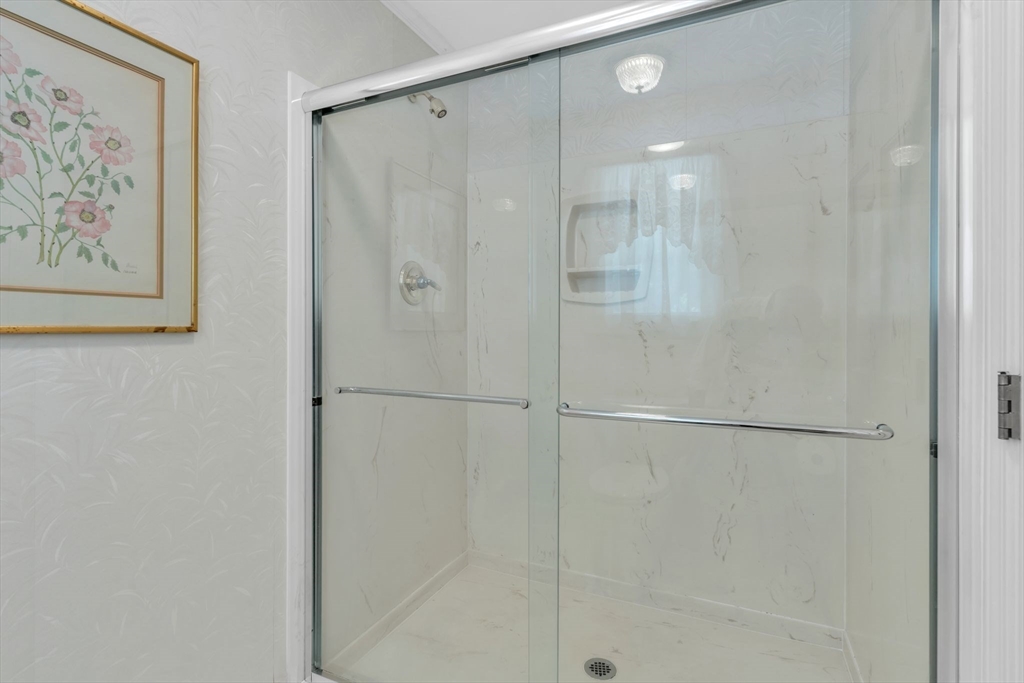 63 Ardsley Road Longmeadow, MA 01106 - Photo 21 of 41 a bathroom with a shower and a glass door