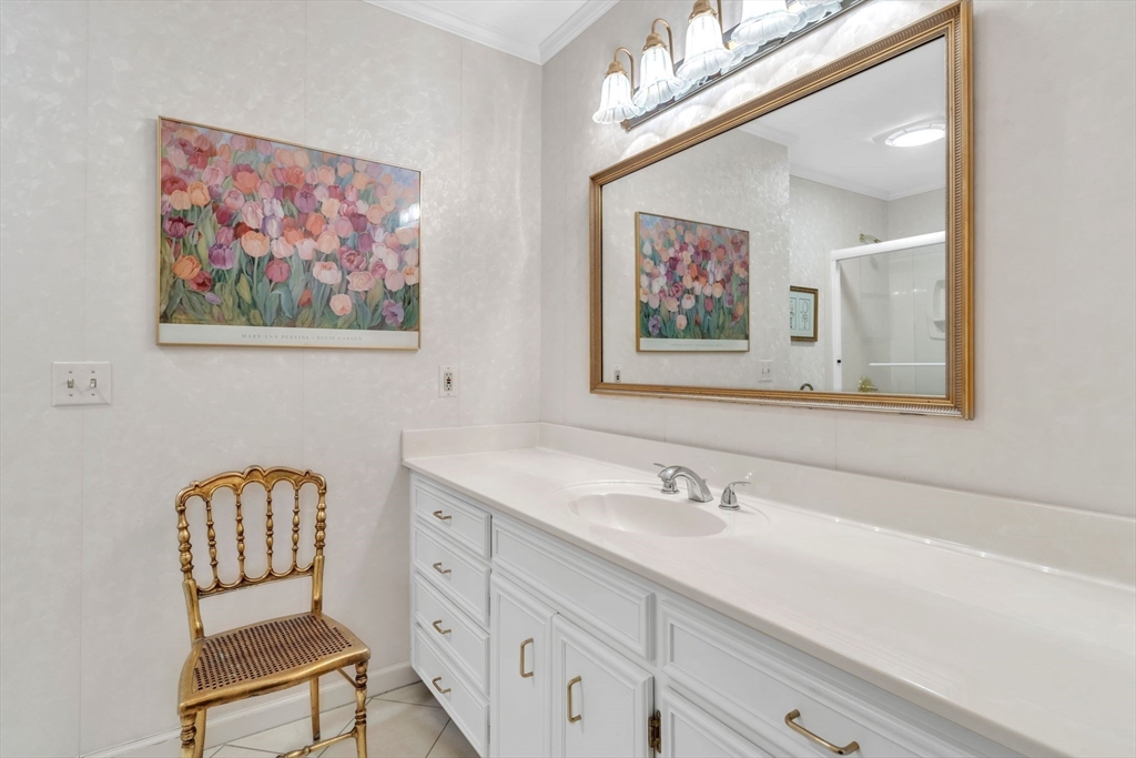 63 Ardsley Road Longmeadow, MA 01106 - Photo 22 of 41 a bathroom with a granite countertop sink a mirror and a picture on the wall