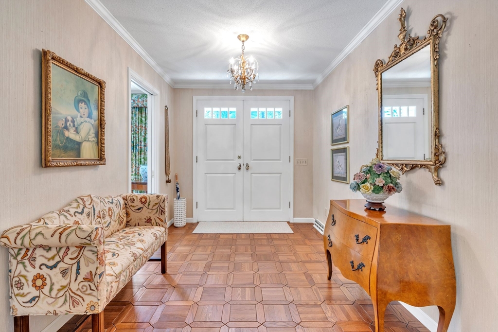 63 Ardsley Road Longmeadow, MA 01106 - Photo 3 of 41 a spacious bedroom with a bed and a chandelier