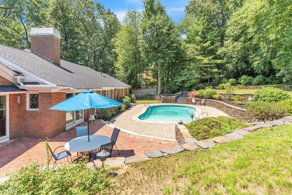 63 Ardsley Road Longmeadow, MA 01106 - Photo 31 of 41 a view of a backyard with chairs and table under an umbrella