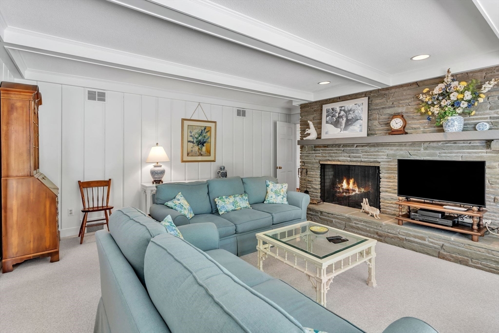 63 Ardsley Road Longmeadow, MA 01106 - Photo 9 of 41 a living room with furniture a flat screen tv and a fireplace