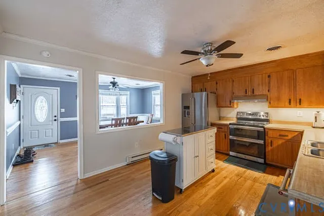 a kitchen with a refrigerator a stove top oven a sink and dishwasher