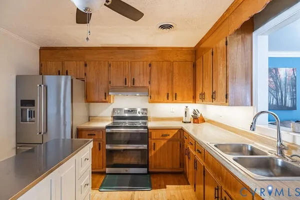 a kitchen with a sink stove and refrigerator