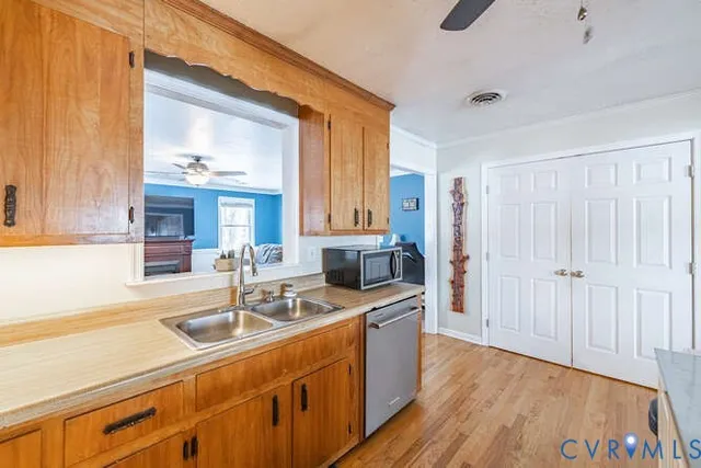 a kitchen that has a sink and a oven with wooden floor