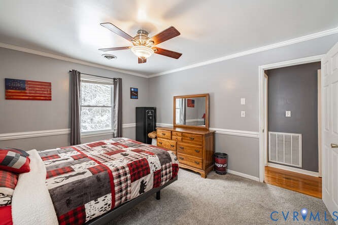 11623 Cox Road Church Road, VA 23833 - Photo 24 of 41 a bedroom with a bed and a chandelier