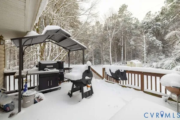 a view of a house with a yard covered in snow