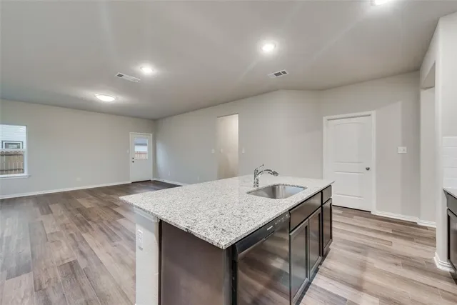 a kitchen with a granite countertop sink and mountain view