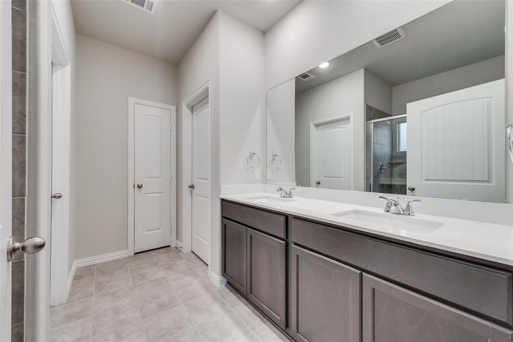 3709 Washington Street Greenville, TX 75401 - Photo 15 of 24 a bathroom with a double vanity sink mirror and double