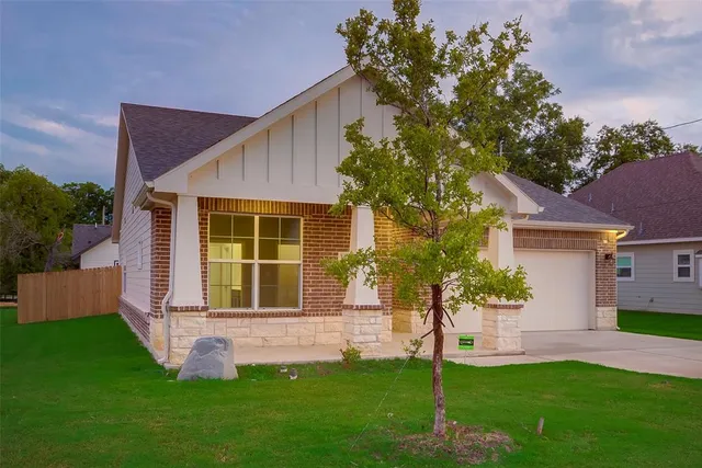 a front view of a house with a yard and porch