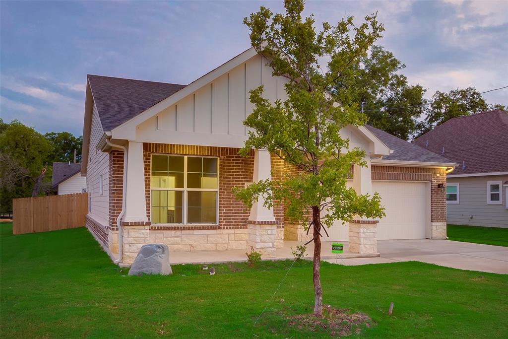 3709 Washington Street Greenville, TX 75401 - Photo 4 of 24 a front view of a house with a yard and porch