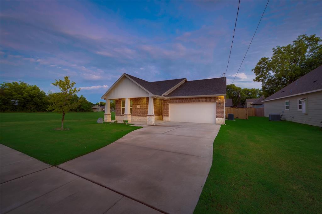 3709 Washington Street Greenville, TX 75401 - Photo 5 of 24 a front view of house with a yard and green space