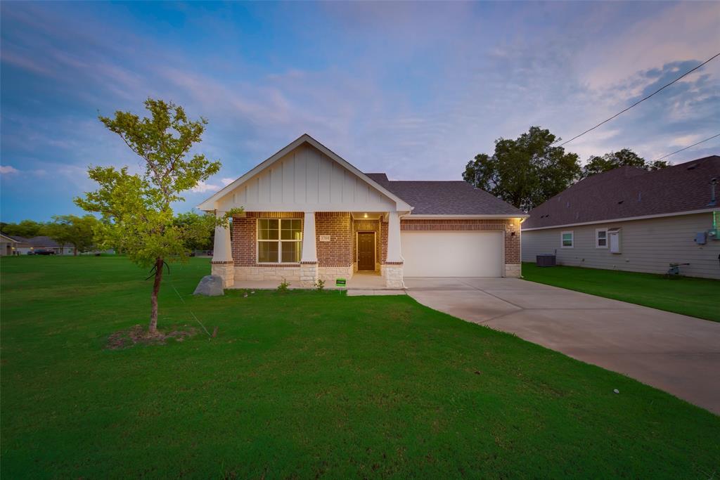 3709 Washington Street Greenville, TX 75401 - Photo 7 of 24 a front view of a house with a yard and trees