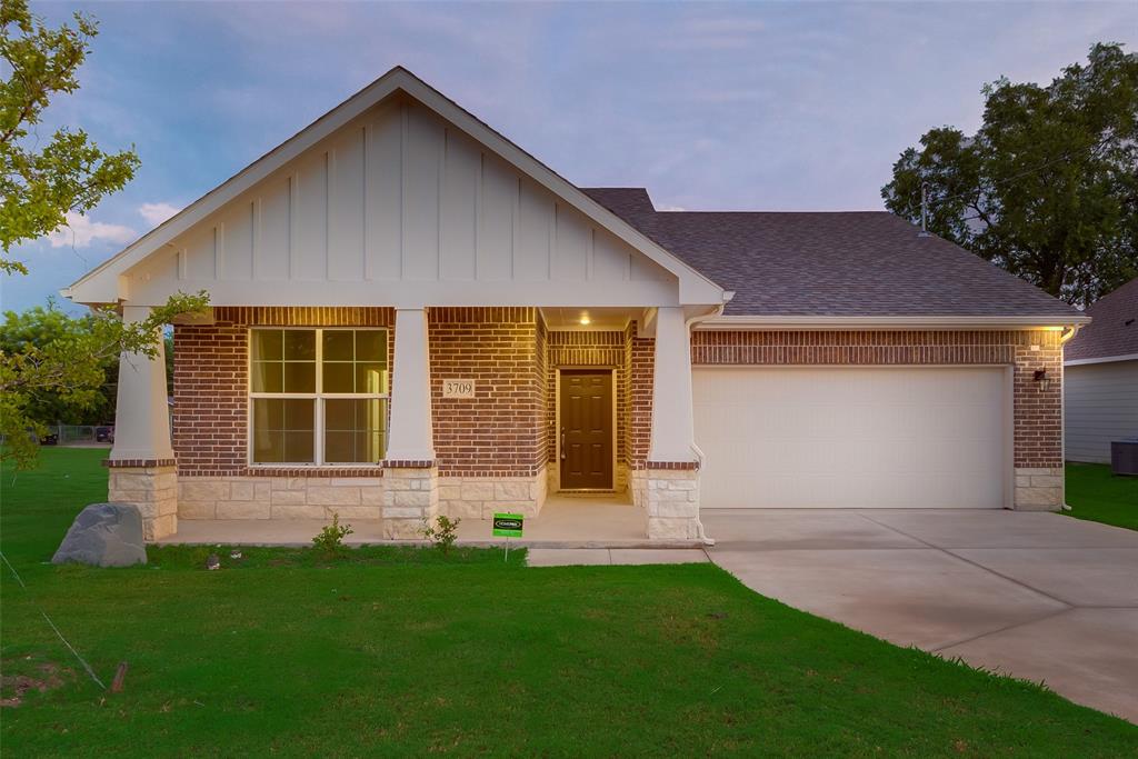 3709 Washington Street Greenville, TX 75401 - Photo 8 of 24 a front view of a house with a yard and garage