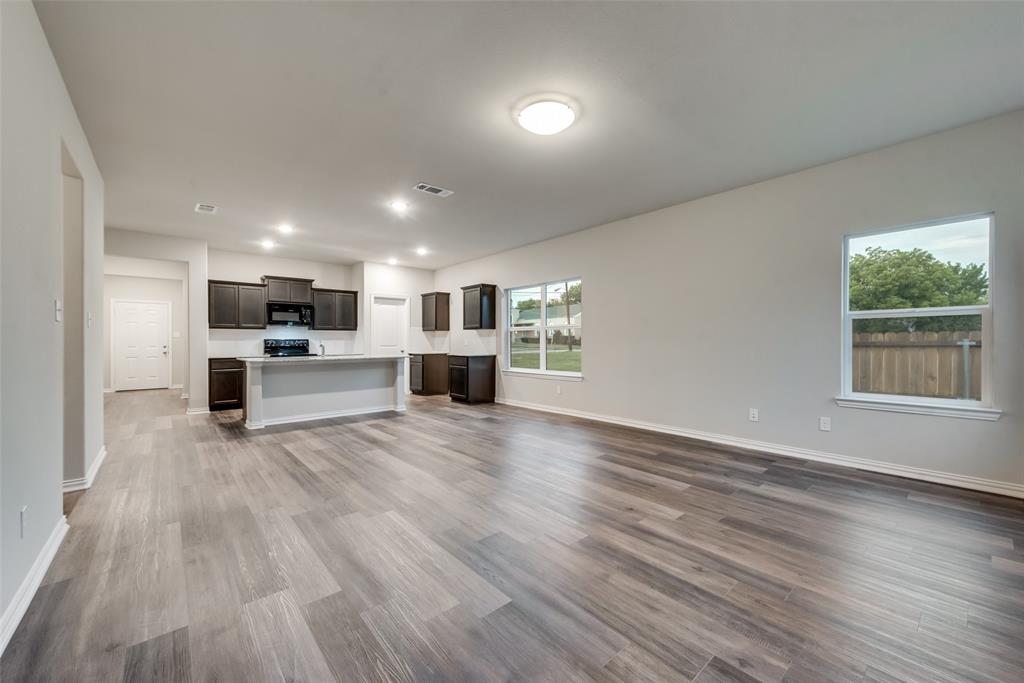 3709 Washington Street Greenville, TX 75401 - Photo 9 of 24 a view of kitchen with wooden floor electronic appliances and window