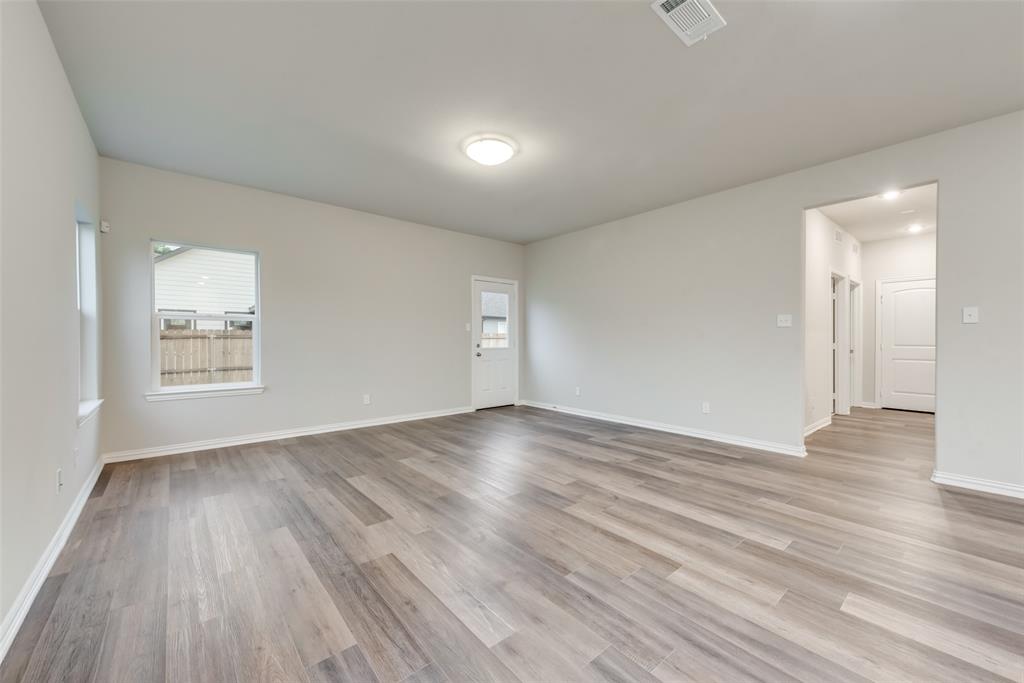 3709 Washington Street Greenville, TX 75401 - Photo 10 of 24 an empty room with wooden floor and windows