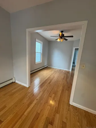 wooden floor in an empty room with a window
