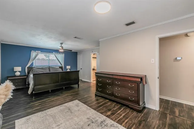 a spacious bedroom with a bed and a chandelier